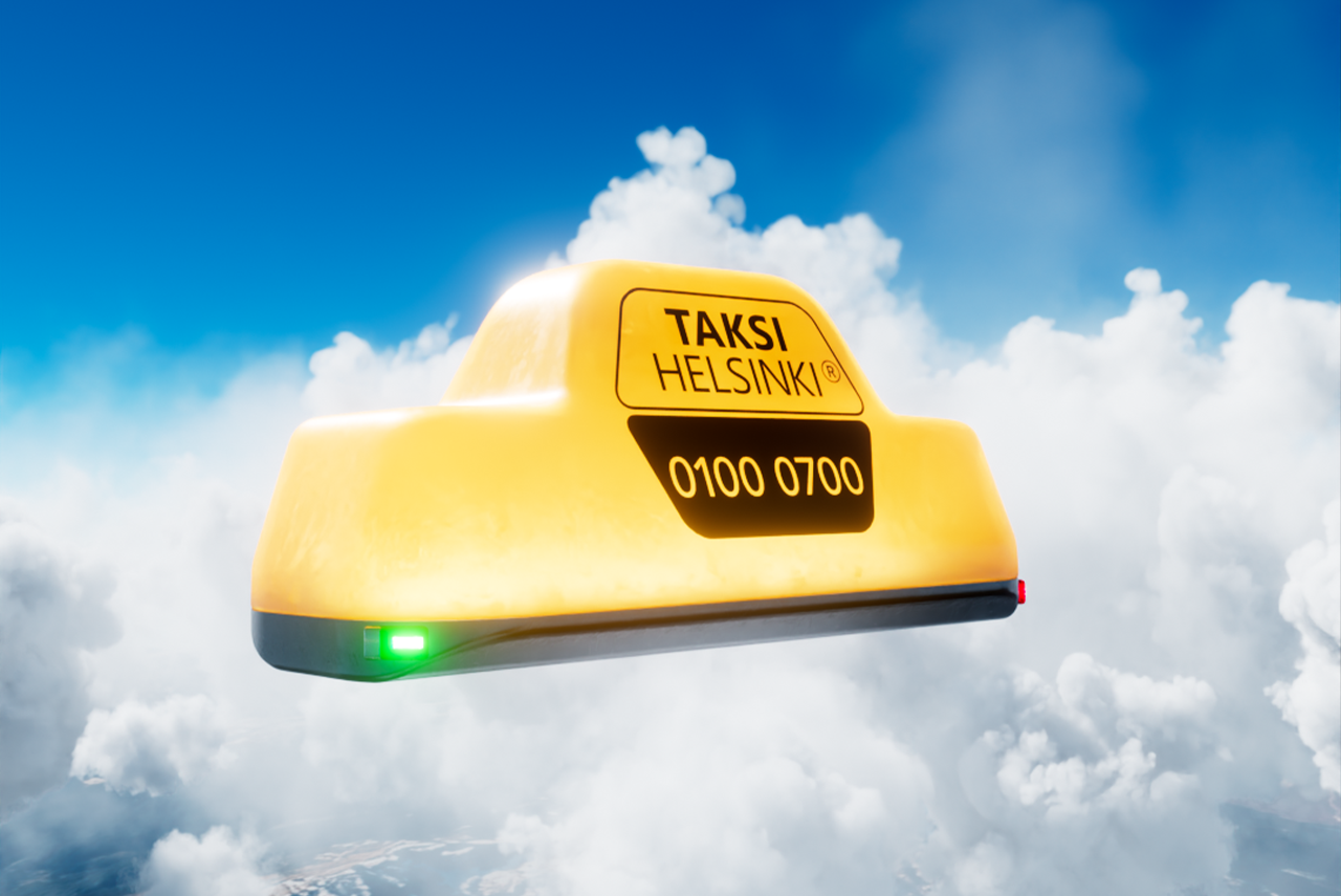 An image showing a Taksi Helsinki taxi sign against a background of clouds and blue sky.